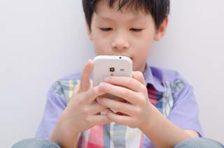 child holding mobile phone