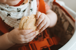 A toddler holding a toddler snack