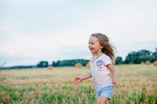 Girl running in field